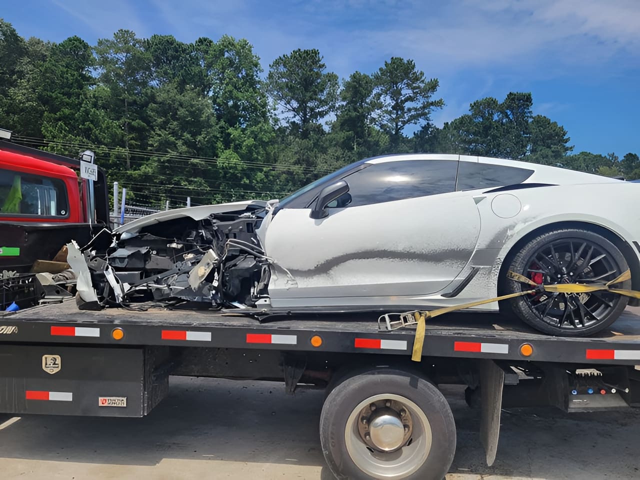 Wrecked white sports car secured on an R3P Transport rollback